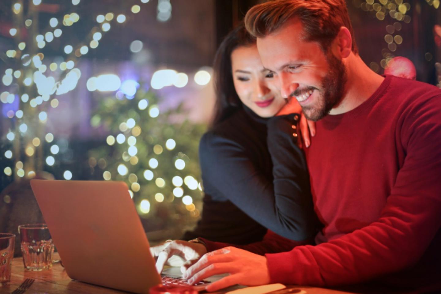 Young couple using a laptop at Christmas time